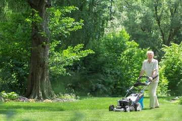 Retired man mowing the grass