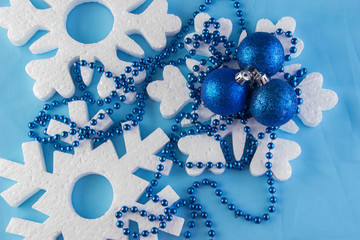 New Year card with blue balls, white snowflakes foam, orange tan