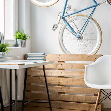 Vertical picture of trendy bicycle in small room