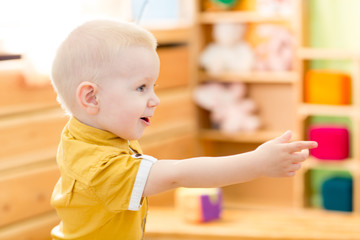 Happy kid playing in kindergarten room