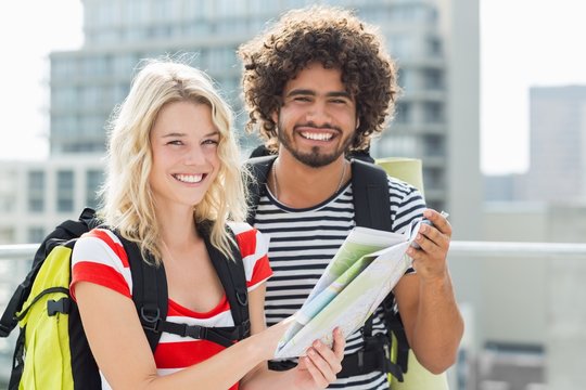 Young couple holding map