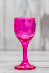 Pink Glass on white wooden background