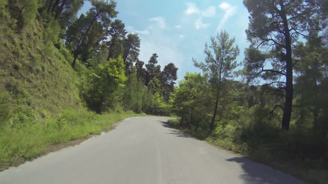 POV of a driving car along a mountain road in Greece looking forward