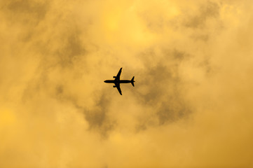 Fototapeta na wymiar airplane flying in the blue sky with clouds