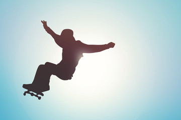 skateboard - skater silhouette against blue sky at sunset