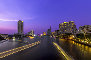 Light effects over time after sunset on the river in a Bangkok c