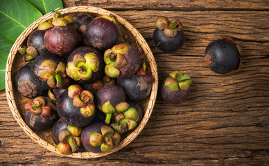 Mangosteen in basket on wood background