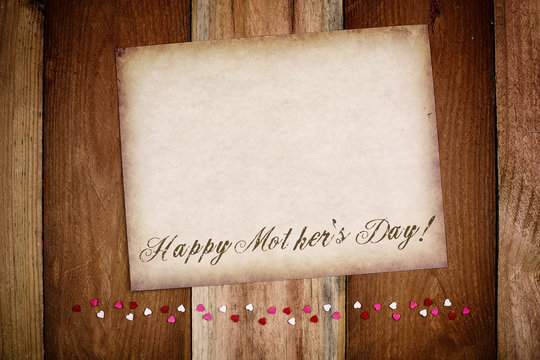 Happy Mother's Day background 
Old paper on the wood with small hearts