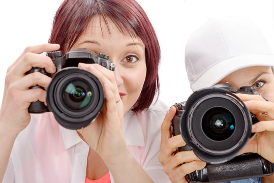 Two beautiful young women using a camera