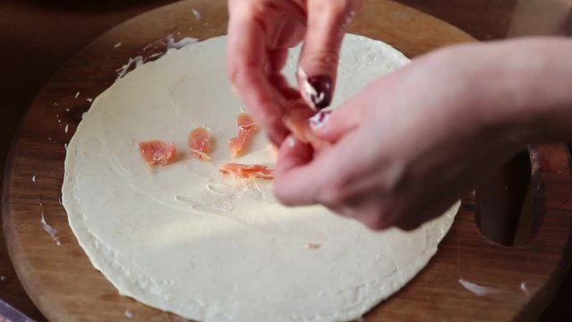 Cooking Mexican tortilla with salmon