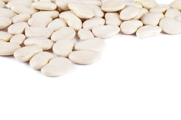 white haricot beans scattered on a white background