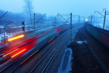 movement of trains in the ways of evening twilight fog Spring