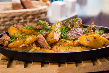 meat with potatoes in pen