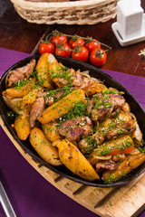 meat with potatoes in pen