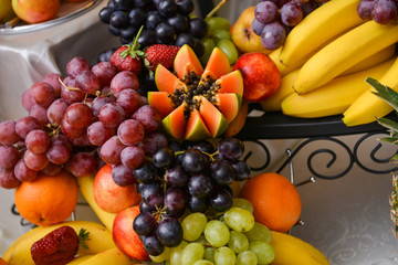 Naklejka na ściany i meble Different type of grapes, papaya and bananas on a table