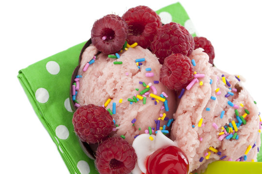 cropped image of strawberry ice cream with raspberry with sprinkles
