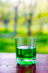 Glass of green absinth