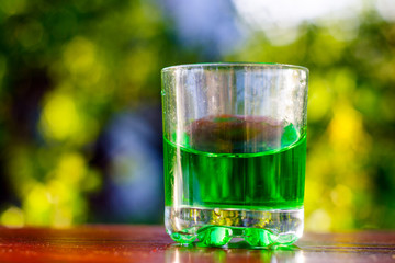 Glass of green absinth