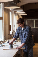 Carpenter Using Electric Sander. Carpenter sanding a wood with s