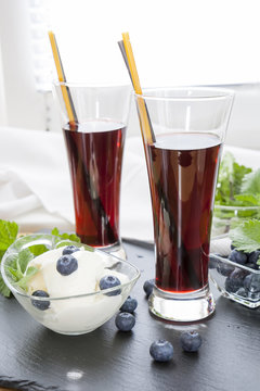 Ice cream with Bog blueberry and lemon balm, Glasses with fresh Black Currant juice