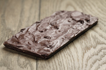homemade chocolate with almond nuts on wood table, shallow focus