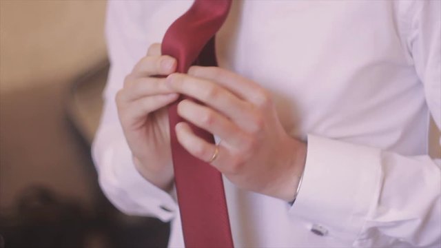 Groom Straightens His Tie Hands