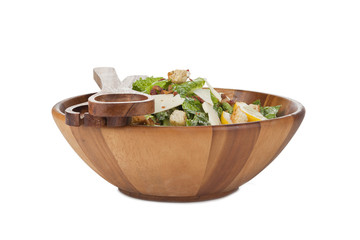 ceasar salad in wooden bowl with utensils
