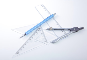 pair of compasses drawing circle on a paper