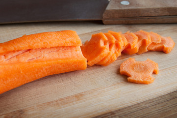 carrots in a pattern, wooden board and knife