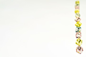 Background with plastic fake jewels on white background
