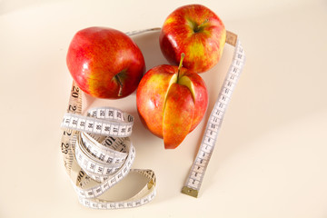 Stethoscope with red apples on a white background