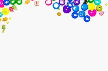 Background with plastic fake jewels on white background
