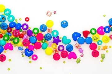 Background with plastic fake jewels on white background
