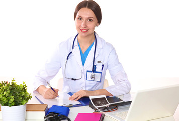 Happy smiling young beautiful female doctor showing blank area for sign or copyspace, isolated over white background