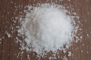 Sea salt on a wooden brown background