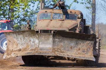 Fototapeta premium soviet military bulldozer drives on track 