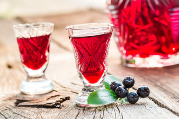 Fresh liqueur made of chokeberries and alcohol