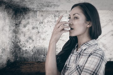 Composite image of portrait of an asthmatic woman 