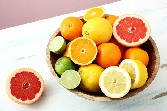 frutta,agrumi interi e tagliati sfondo colorato