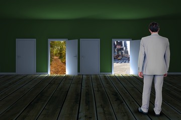 Composite image of rear view of businessman walking on white bac