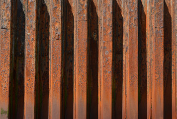 Rusty metal groynes in sea defense wall