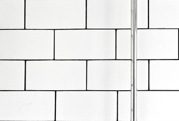 White vintage metro tiles and black grout in a bathroom