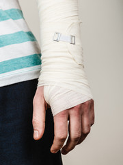Part body man with bandaged hand.
