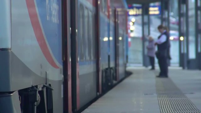 Last passengers running to train, conductor controlling discipline, slowmotion