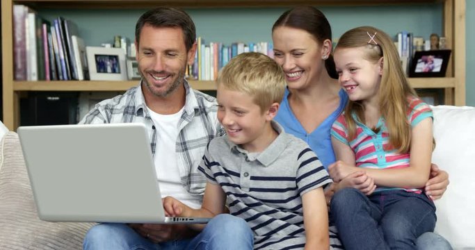 A happy family is using a computer