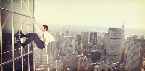 Composite image of businessman pulling a rope