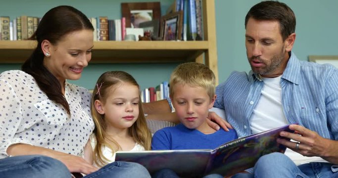 A happy family is reading a book