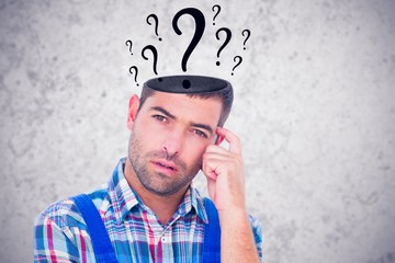 Composite image of portrait of confused manual worker scratching