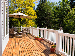 Home outdoor cedar deck with blooming trees  - 109905920