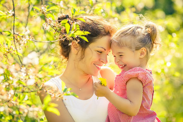 Mother and daughter in spring sunny park